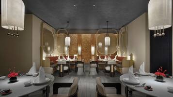 Un comedor moderno con mesas redondas, sillas e iluminación colgante.