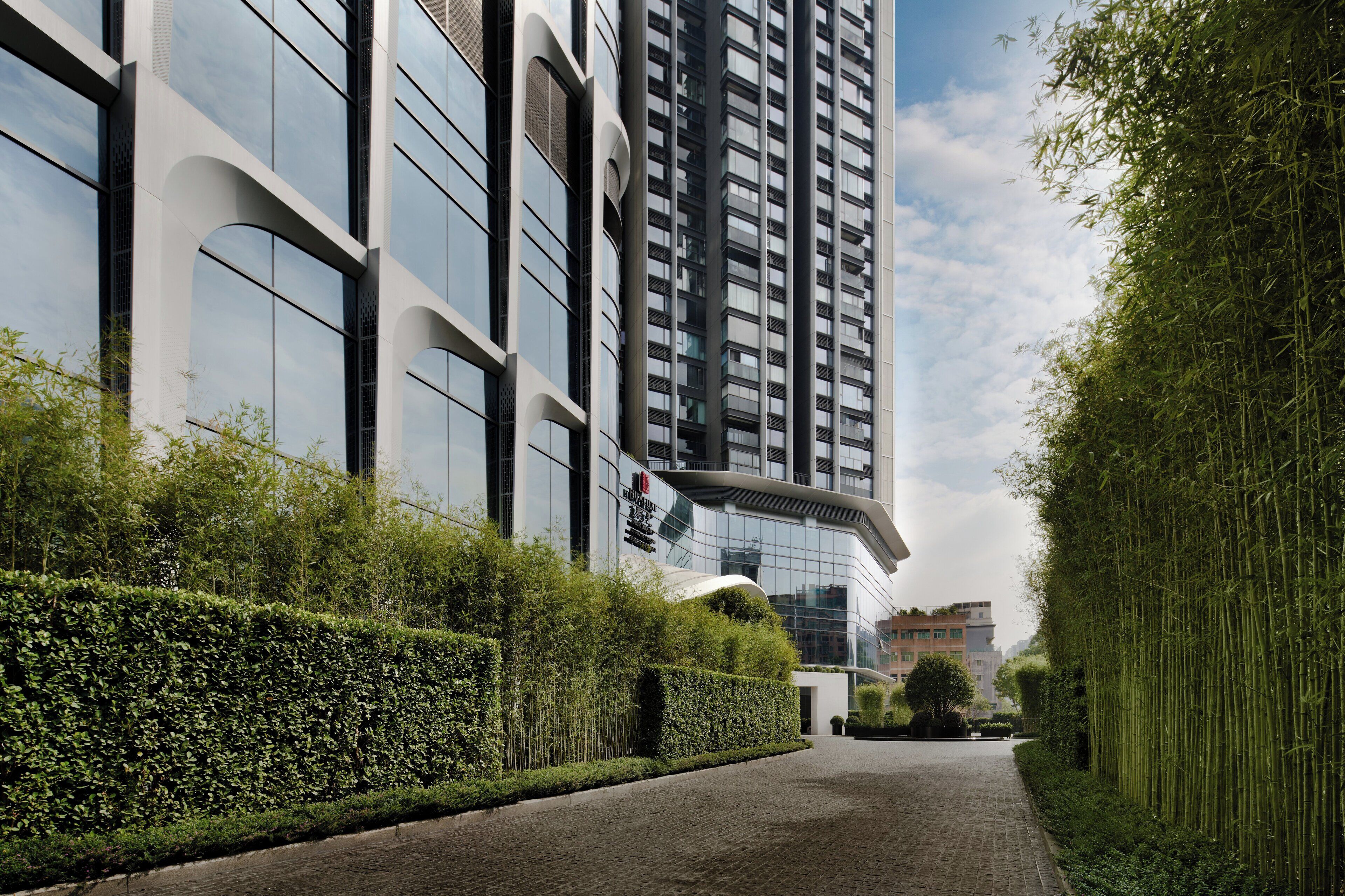 A modern building with large windows and a paved pathway.