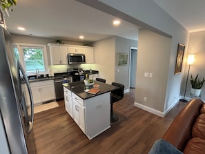 Enjoy a compact yet functional space with a kitchenette, dining area, and living space, perfect for relaxation.
