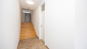 A narrow hallway with a wooden staircase leading to a door. - Pet friendly apartment in Imotski with WiFi (Imotski)