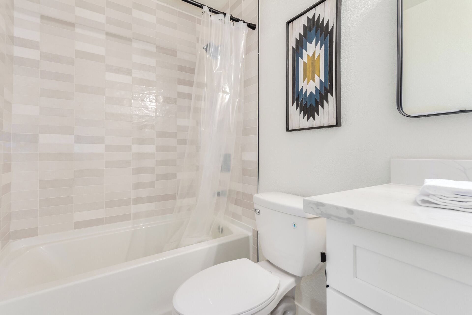 A bathroom with a shower, toilet, and sink.