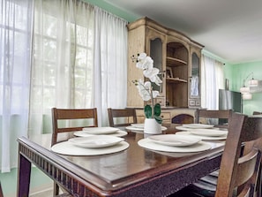 Classic dining area with a traditional table for six and ornate storage cabinet.
