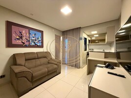 Luxury Apartment | Living area | 34-inch flat-screen TV with digital channels, pay movies