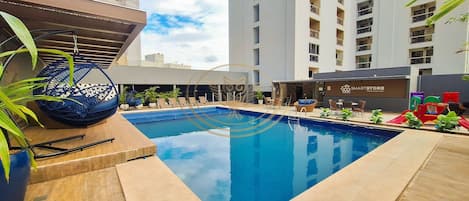 Outdoor pool, open 6:00 AM to 10:00 PM, pool umbrellas, sun loungers