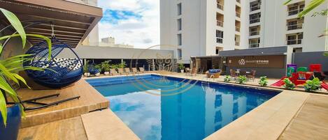 Outdoor pool, open 6:00 AM to 10:00 PM, pool umbrellas, pool loungers