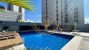 Outdoor pool, open 6:00 AM to 10:00 PM, pool umbrellas, pool loungers