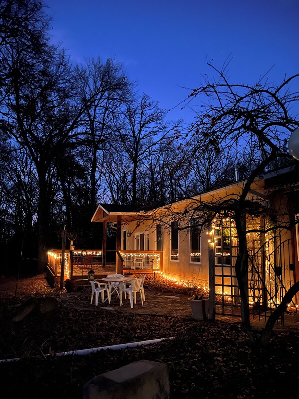 A house with a patio area, outdoor seating, and string lights.