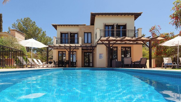 A two-story building with a swimming pool in front.
