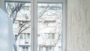 A corner room with a window, a chair, and a white wall. - Varna Central Studio (Varna)