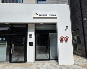 A building with a sign reading "Guest House" and a door with a number "13-23". - Incheon Airport Guesthouse L (Incheon)