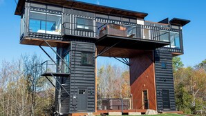 A modern log cabin with a large upper deck and a lower level. - Amazing 34 foot high shipping container home in Whitingham on Sadawga Lake (Whitingham)