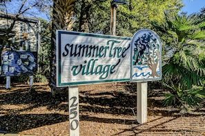 A sign for 'SummerTree Village' with a tree and a mailbox illustration. - Spacious condo with indoor and outdoor pools, hot tub, close to MB attractions (Myrtle Beach)