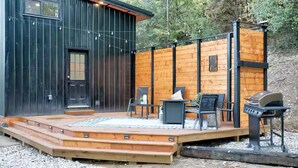 A rustic cabin with a wooden deck, outdoor seating, and a barbecue grill. - Sleeps 5-6 Near RRG-Hot Tub-Nice Sunrise-Quiet (Beattyville)