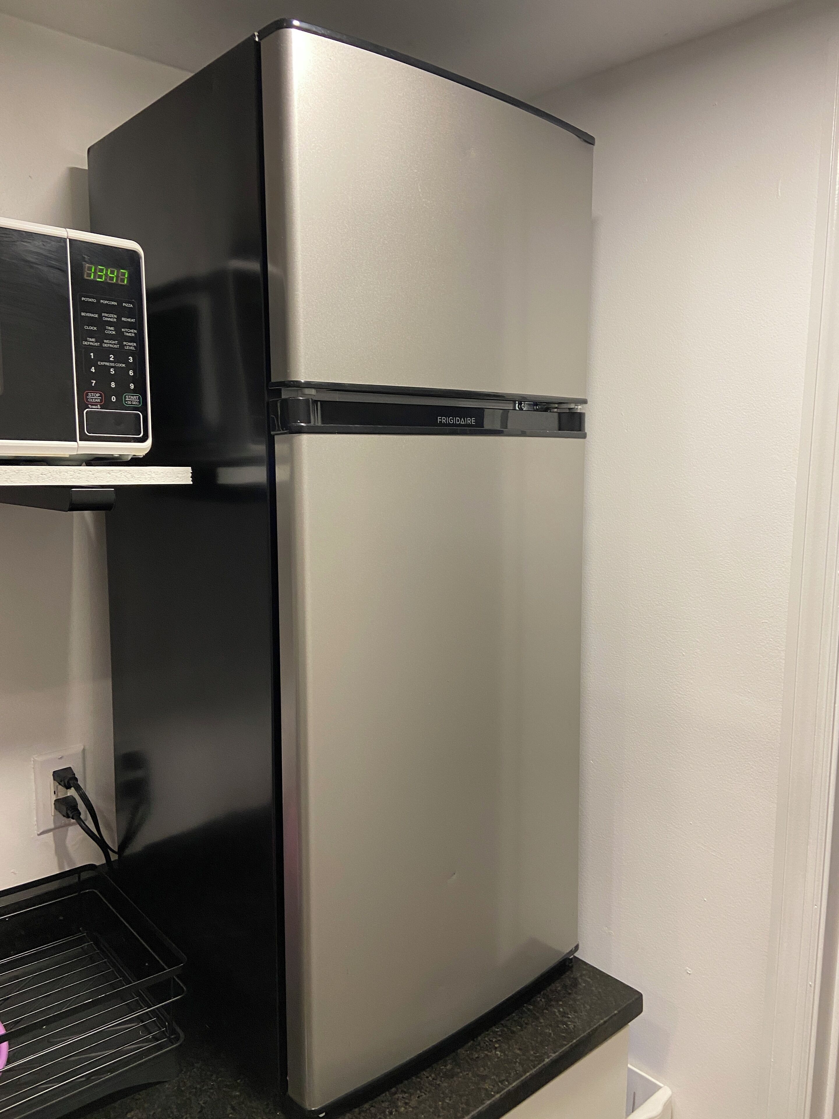 A stainless steel refrigerator with a digital display and a freezer compartment.