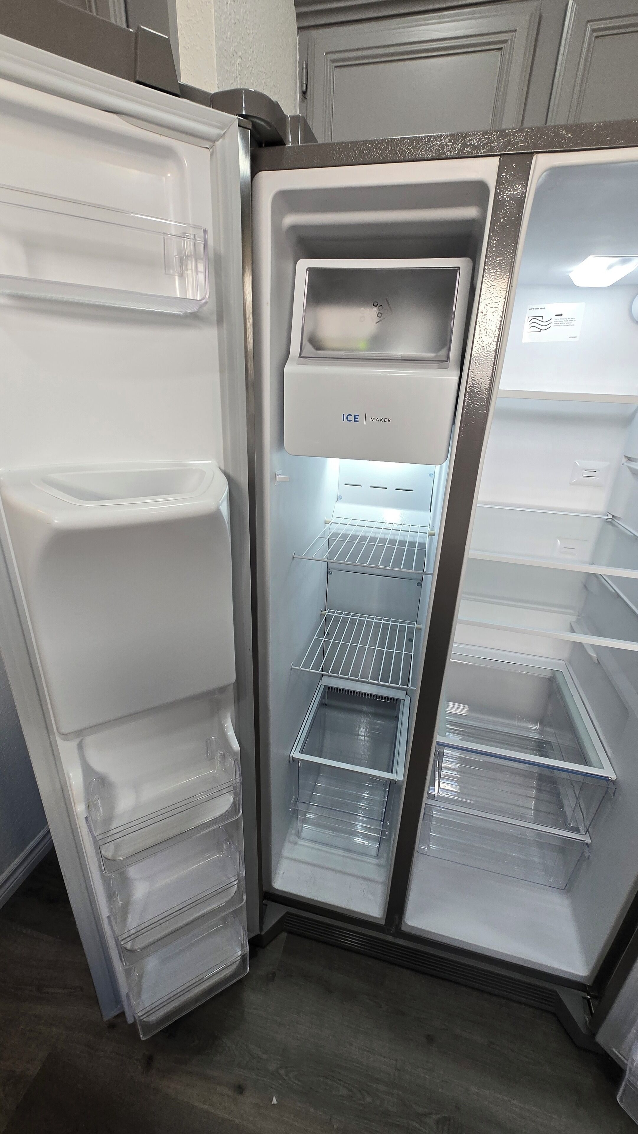 An open refrigerator with multiple shelves and a freezer compartment.