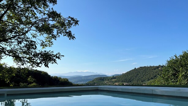 A clear view of a swimming pool with a mountain landscape in the background.