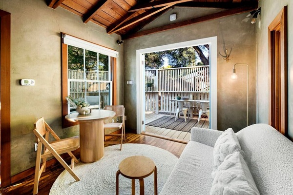 This inviting living and kitchen space opens up to a tranquil private patio for a perfect retreat.