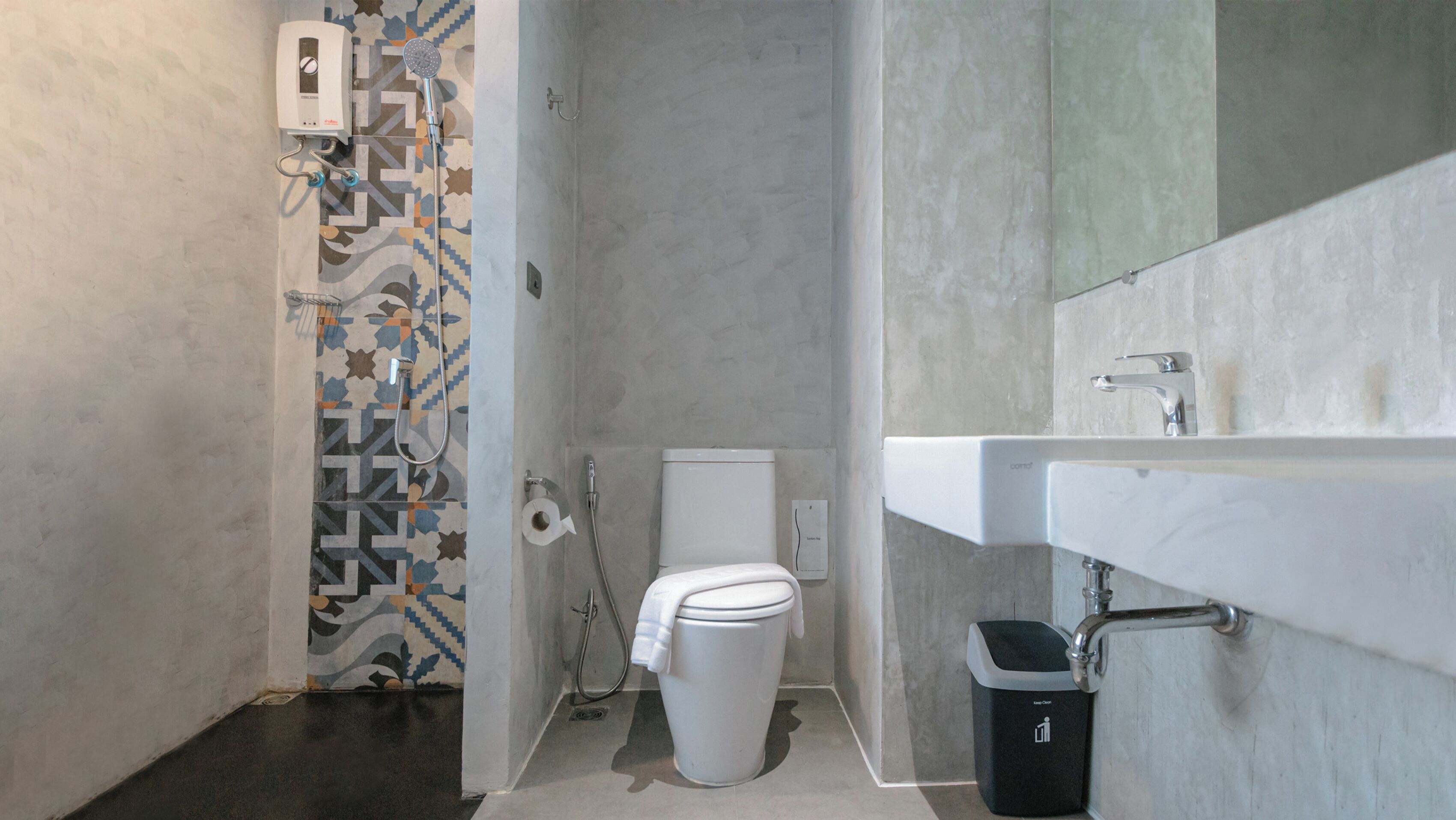 A modern bathroom with a shower, toilet, and sink.