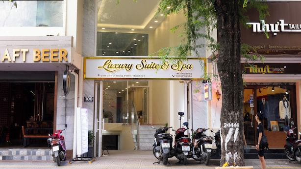 A building with a sign for "Luxury Suite & Spa" and several motorcycles parked outside. - Ben Thanh Luxury Suite Hotel & Spa (Ho Chi Minh City)