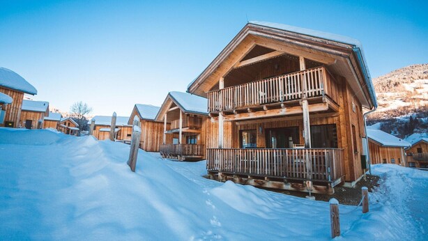 A wooden chalet with a balcony, surrounded by snow-covered ground. - Appealing chalet in the ski area (Sankt Georgen am Kresichberg)