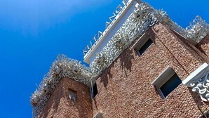 A building with a distinctive architectural style, featuring ornate metalwork and a clear sky in the background. - Kuta Angel Hotel (Kuta)
