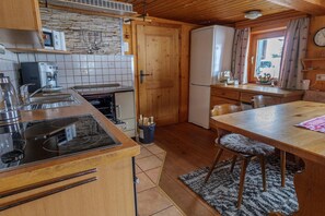 A compact kitchen with a stove, sink, and refrigerator. - Chalet near Passthurn Ski Area Kitzbühel (Mittersill)