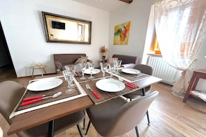 A dining area with a table set for four, including plates, glasses, and cutlery. - Borgo Residence at Tagliacozzo (Tagliacozzo)