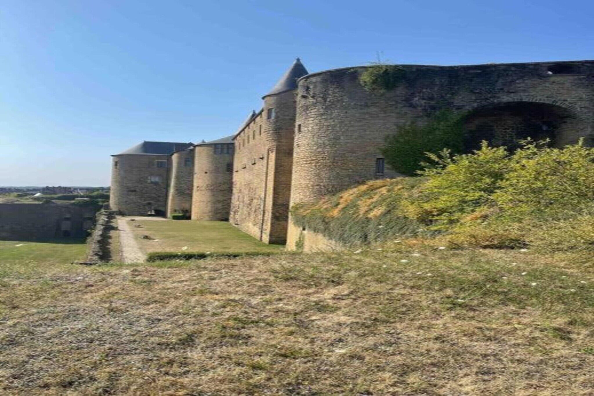 A medieval stone castle with multiple towers and a moat.