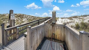 A wooden boardwalk leading to a beach area with a sign indicating beach access. - Romar Beach 203 (Orange Beach)