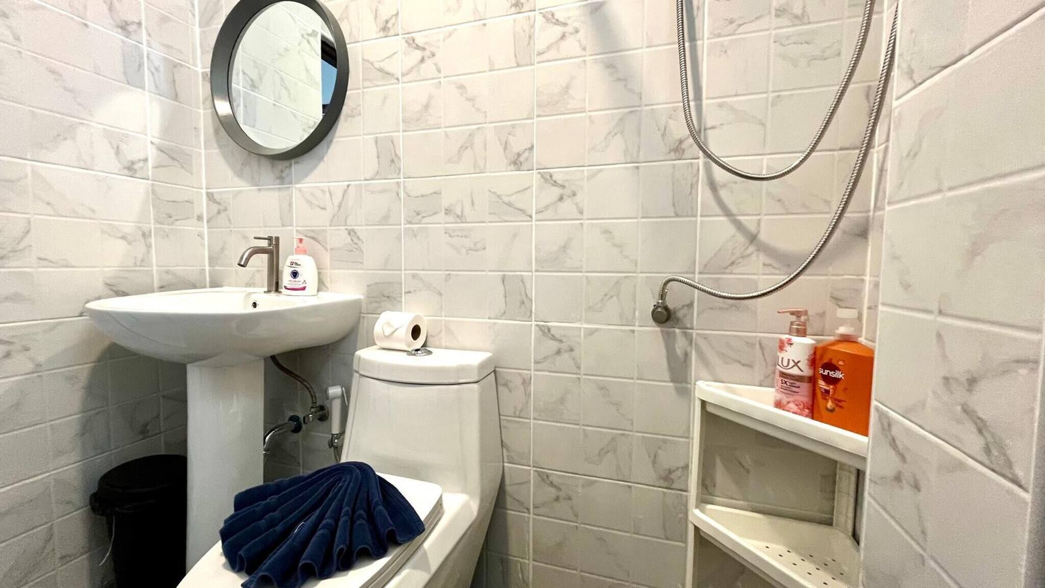 A bathroom with a sink, toilet, and shower.