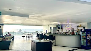 A modern bar area with a bar counter, seating, and a view of the ocean. - B12a - 2 Bdr Serviced Apt with Pool Access, Karon Beach (Tambon Karon)