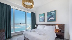 A hotel room with a large bed, a view of the city, and two abstract paintings on the wall. - GLOBALSTAY. Avani Palm View (Dubai)