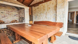 A wooden dining table with benches in a rustic interior featuring stone walls and a wooden ceiling. - Vacation home Iva by Interhome (Karlobag)