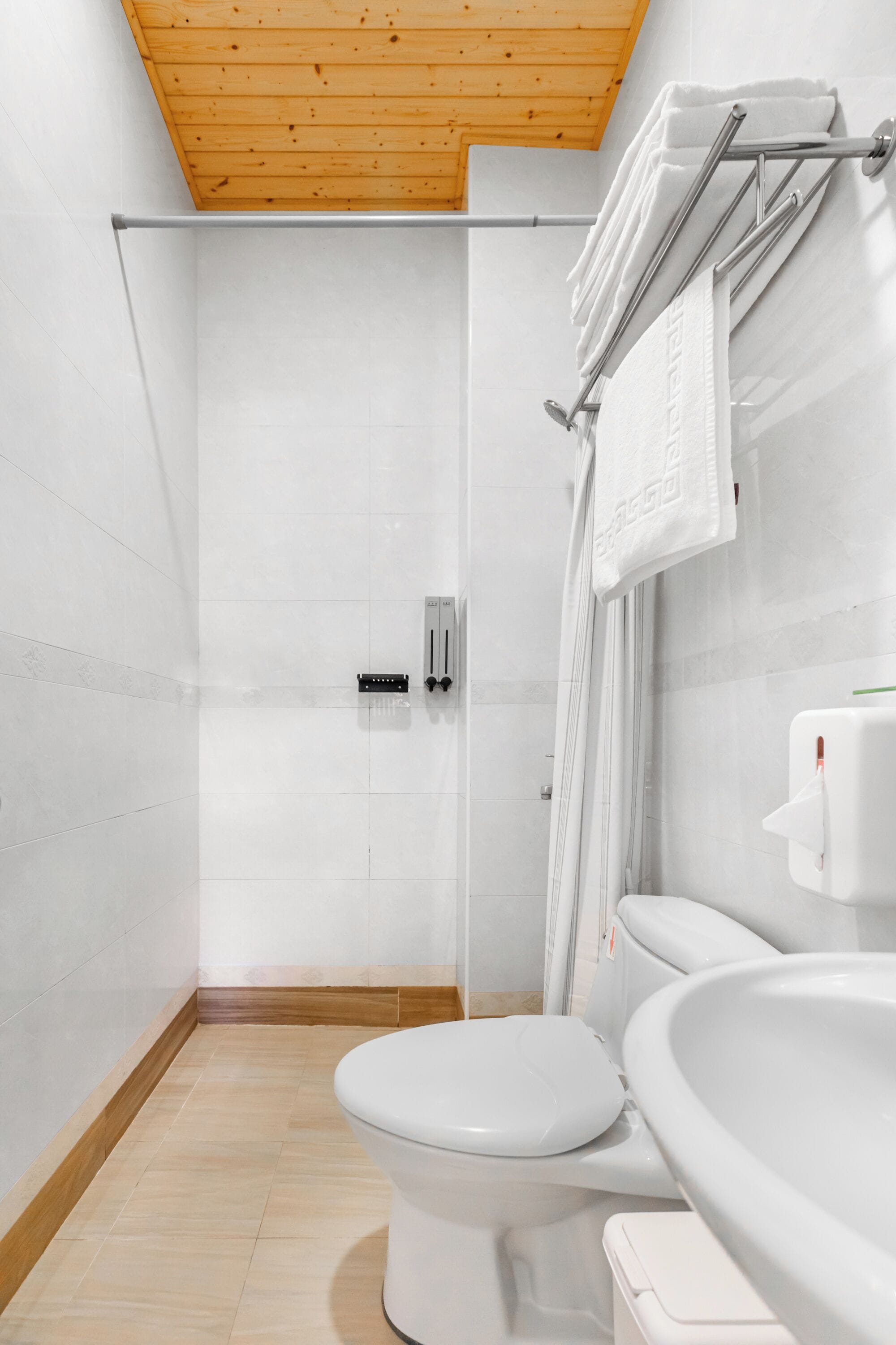 A modern bathroom with a shower, toilet, and sink.