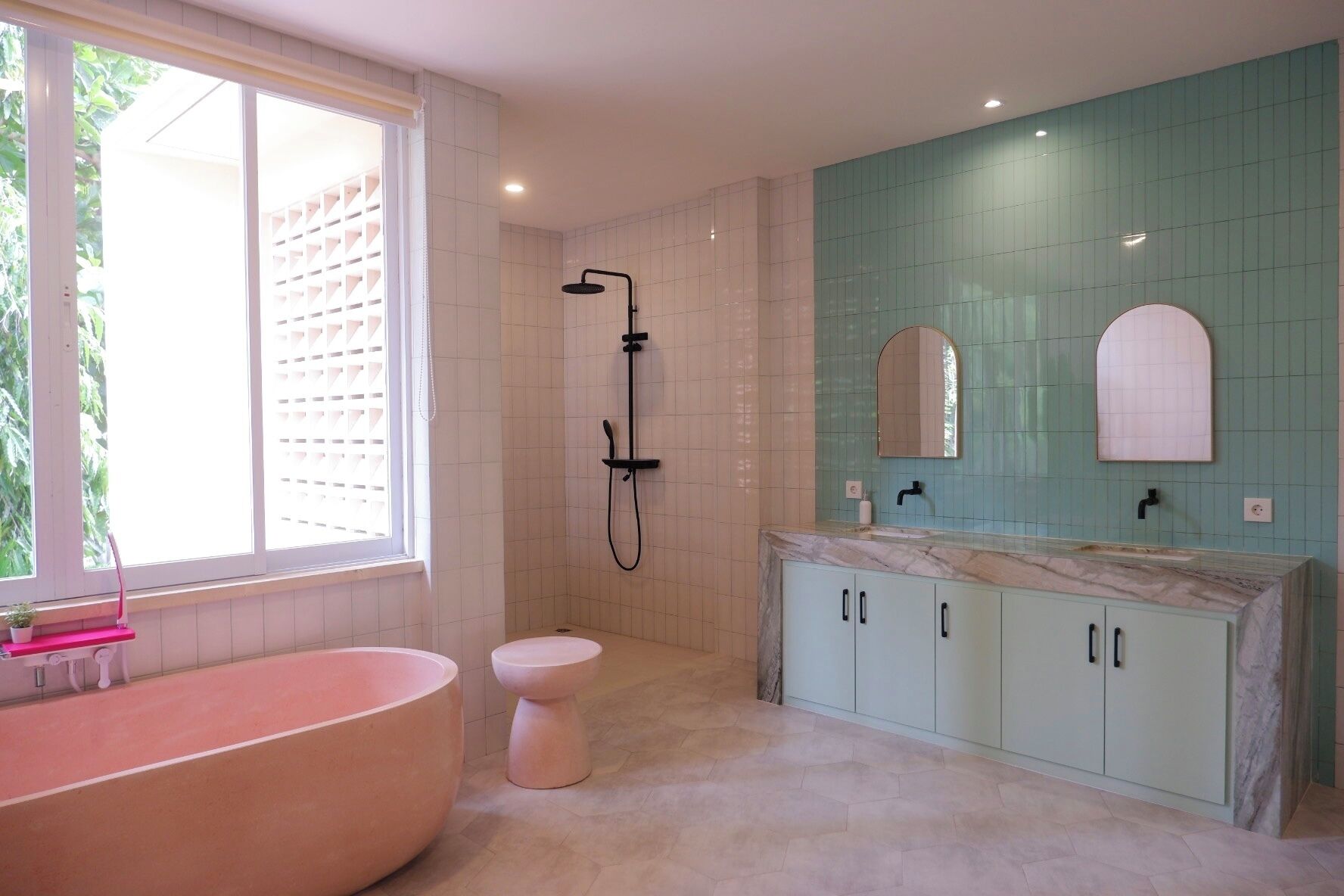 A bathroom with a freestanding bathtub, a shower, a toilet, and a vanity with cabinets.