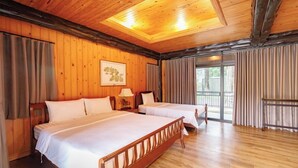 A wooden-paneled room with two beds, a large window, and a ceiling light. - Khaoyai Valley 4 (Pak Chong)