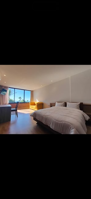 Deluxe Room, 1 Bedroom, Beach View | In-room safe, desk, laptop workspace, iron/ironing board