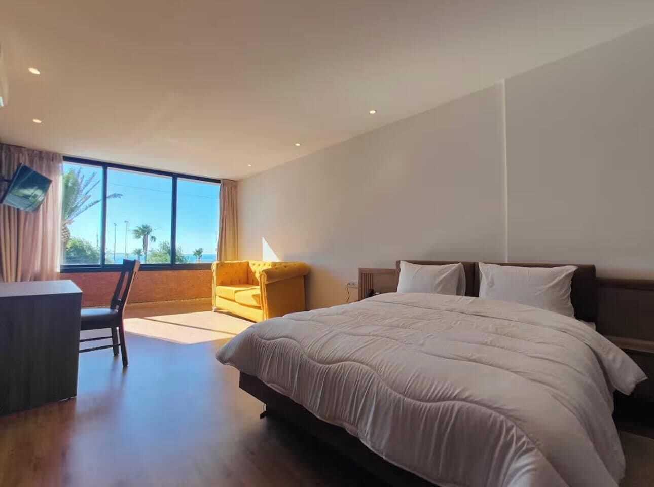 Deluxe Room, 1 Bedroom, Beach View | In-room safe, desk, laptop workspace, iron/ironing board