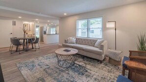 A modern living room with a sofa, coffee table, and dining area. - This house is a 3 bedroom(s), 2 bathrooms, located in Marion, IN. (Marion)