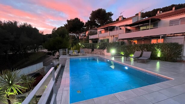 A rectangular swimming pool with a tiled deck, surrounded by lounge chairs and low hedges. - 2. Turquoise - HOME CASSIS - Maison Méditerranée (CASSIS)