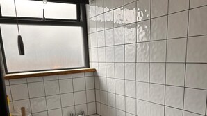A modern bathroom with a bathtub, toilet, and sink. - Chatham Retreat by the River (Chatham)