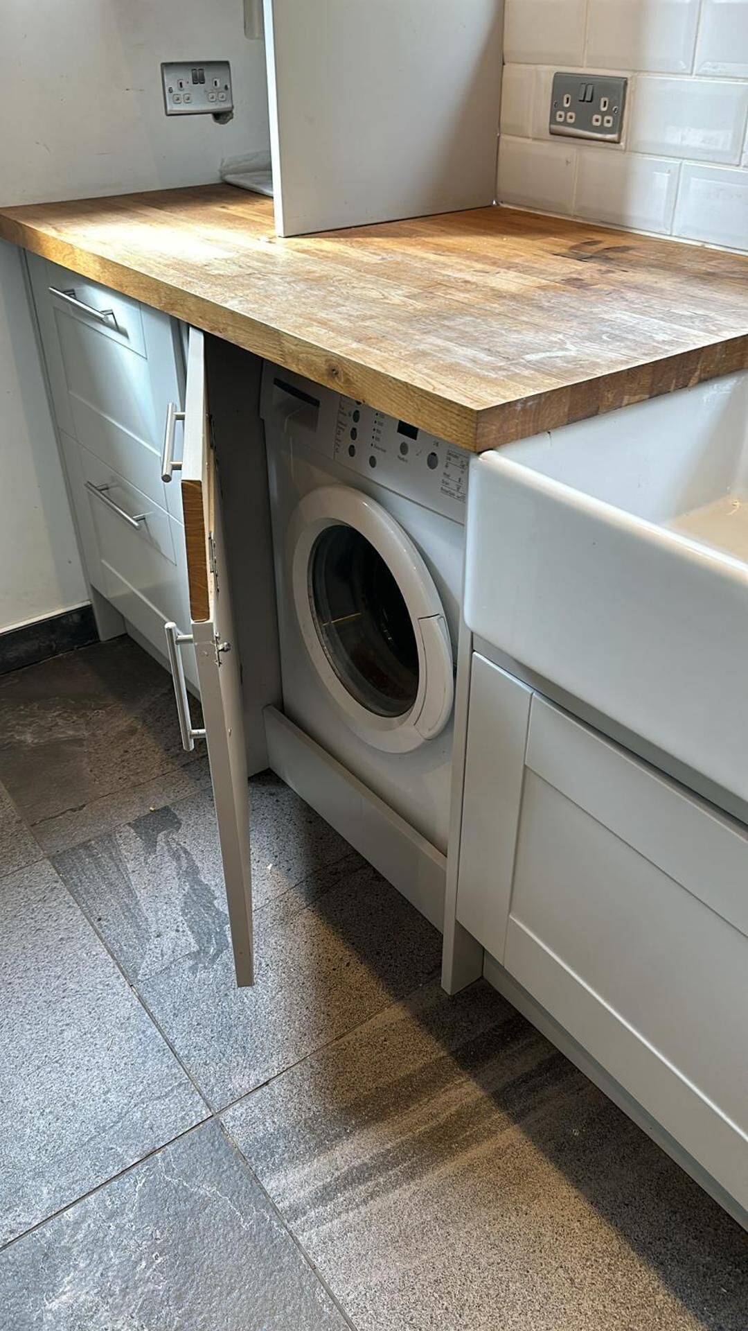 A compact laundry area with a washing machine, a dryer, and a countertop.