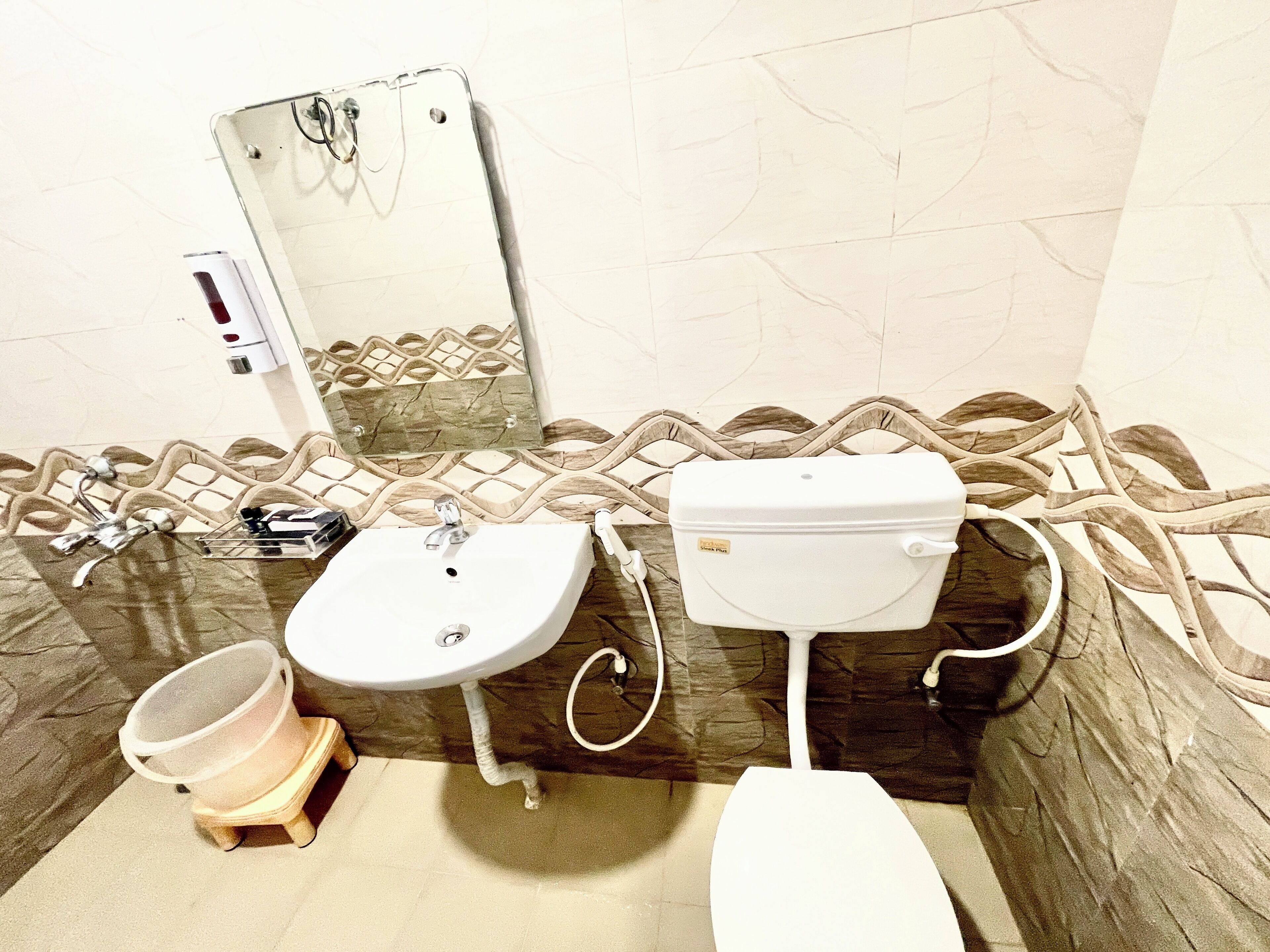 A bathroom with a sink, toilet, and shower area.