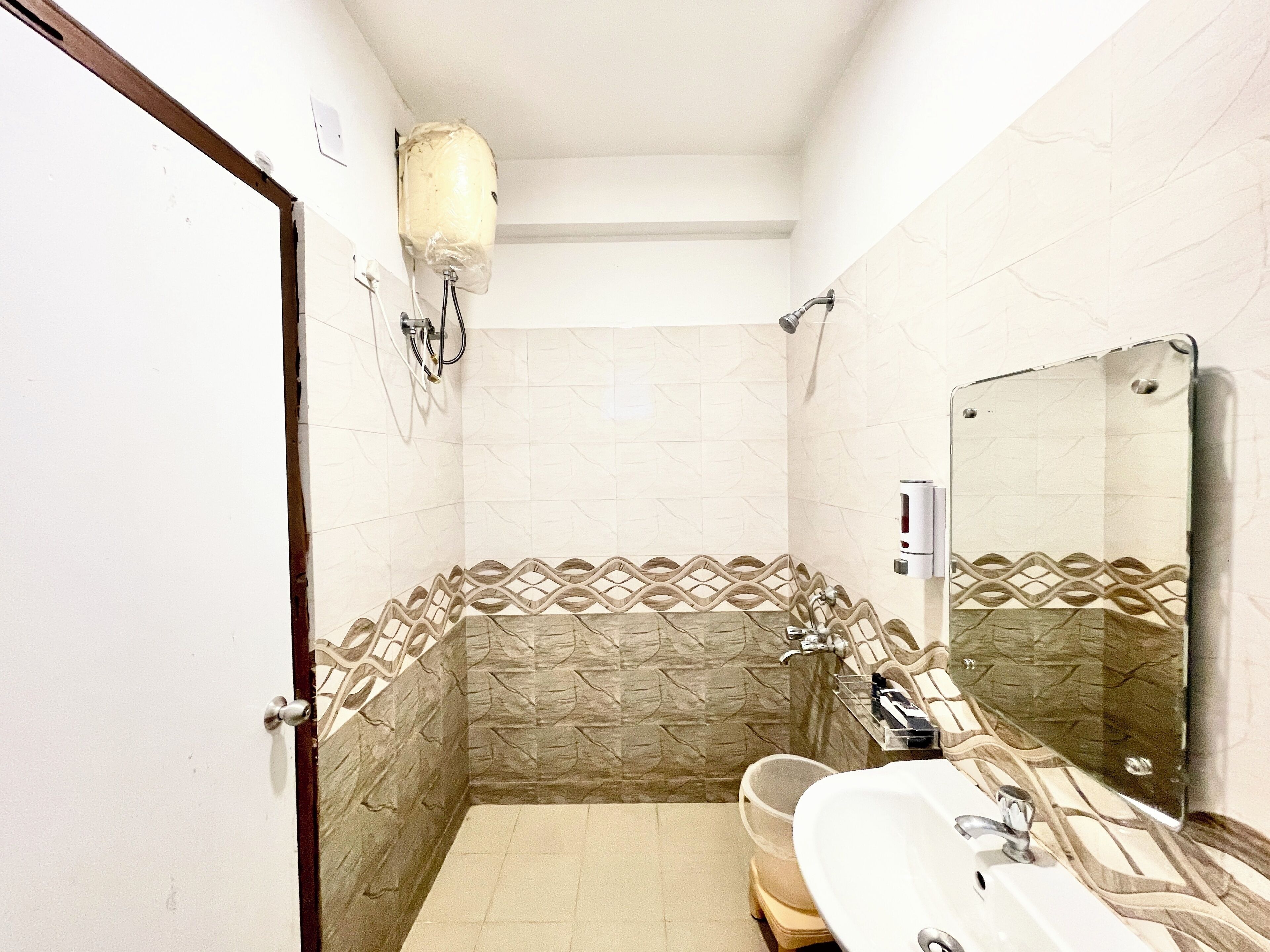 A bathroom with a shower, a sink, and a mirror.