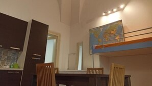 A dining area with a table, chairs, and a map on the wall. - SALENTO SEA AND ART (Nardò)