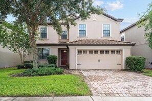 Stunning two-story home with a garage and entrance.