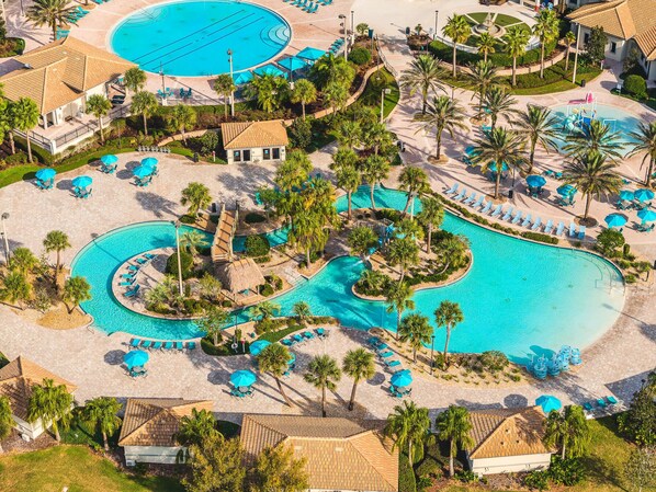 Relax by the large pool surrounded by palm trees and sun loungers, with multiple pools and amenities at your fingertips.