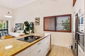 Enjoy cooking in this well-equipped kitchen with a stove and oven, perfect for preparing meals.