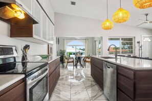 Oven, stovetop, coffee/tea maker, cookware/dishes/utensils - The Mellow Mango  Relaxing 2BR Getaway with Hot Tub, Dock & Cabana Club Access in Key Colony Beach (Key Colony Beach)