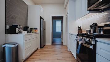 Galley-style kitchen with coffee station and full-size refrigerator